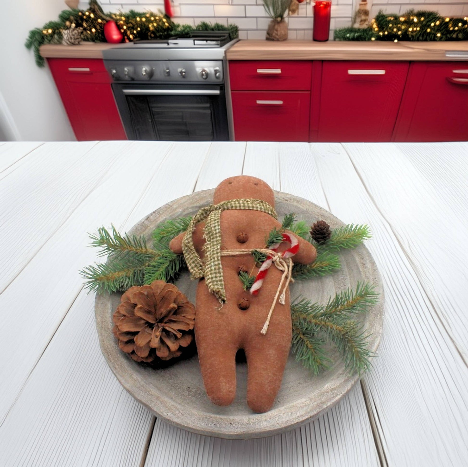 Decorative gingerbread man with greenery on a wooden plate in a kitchen setting