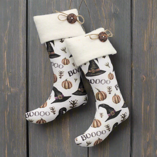 Halloween-themed stocking with pumpkins and witch hats on a gray background