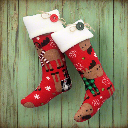 Christmas stocking ornaments with moose on red flannel with white cuffs decorated with buttons