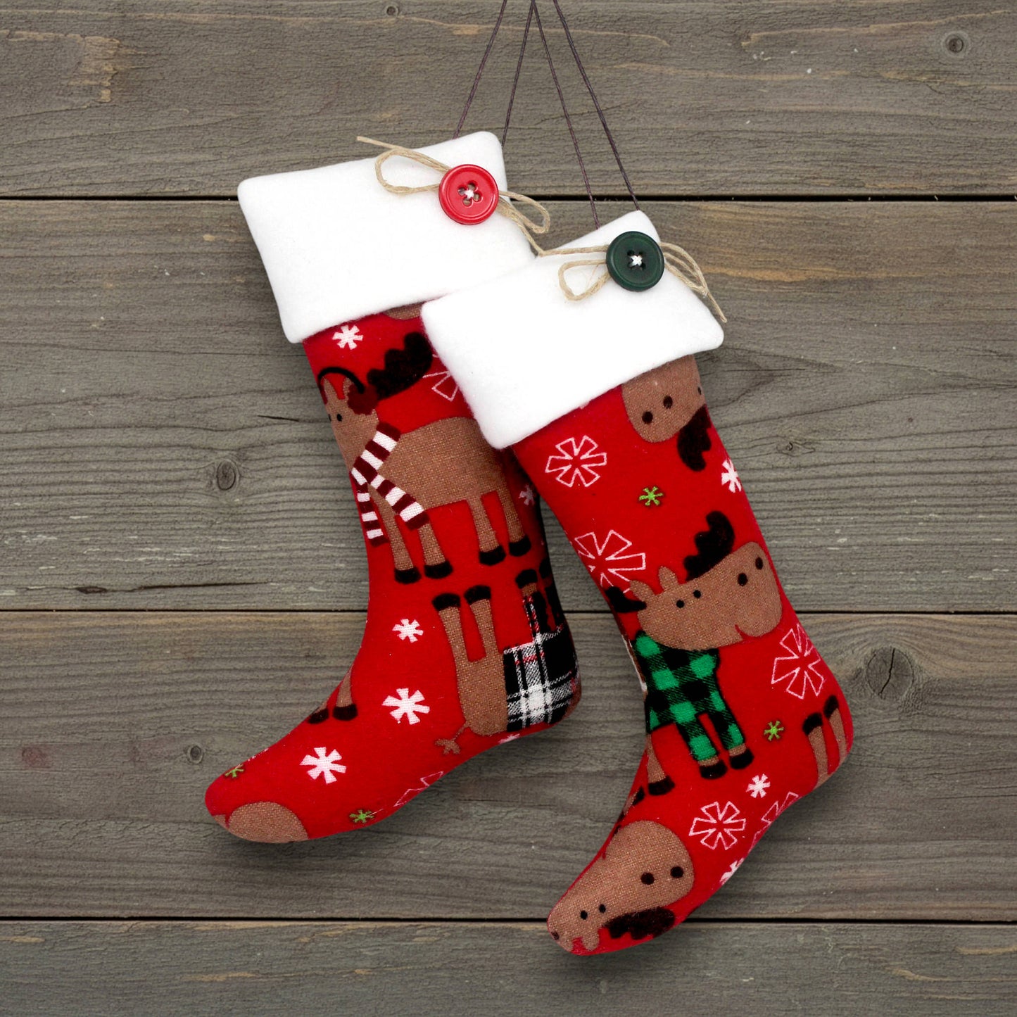 Pair of flannel Christmas stocking ornaments with moose on a red background