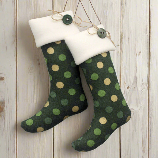 Pair of Christmas stocking ornaments with green and metallic gold polka dots on a dark green background