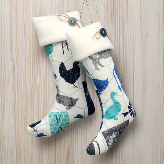 Christmas stocking ornaments with farm animals on a white background with white cuffs