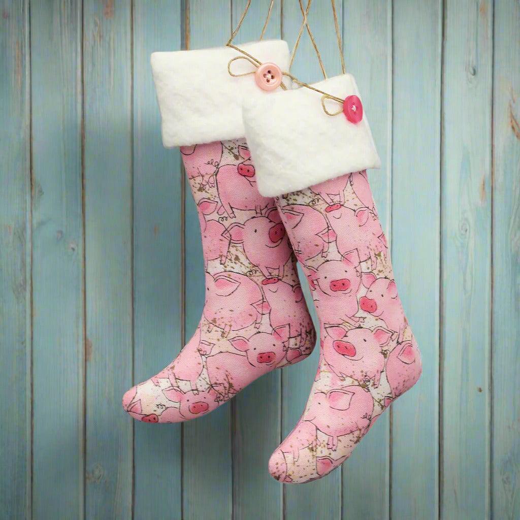Christmas stocking ornaments with cute pink pigs and white cuffs decorated with buttons