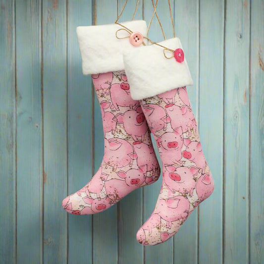 Christmas stocking ornaments with cute pink pigs and white cuffs decorated with buttons