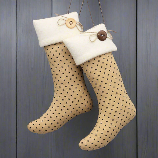 Pair of decorative stockings with tiny star pattern and button details on a wooden background