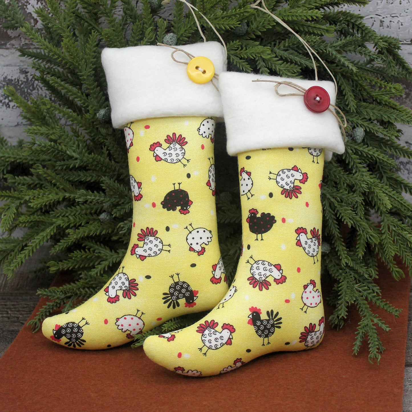 Yellow stockings with chicken pattern and white caps hanging against a green leafy background