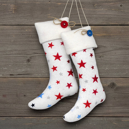 Pair of Christmas stocking ornaments with red and blue stars on a white background