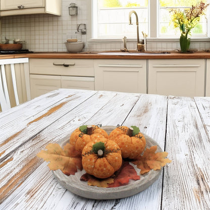 Decorative pumpkins on a wooden table in a kitchen