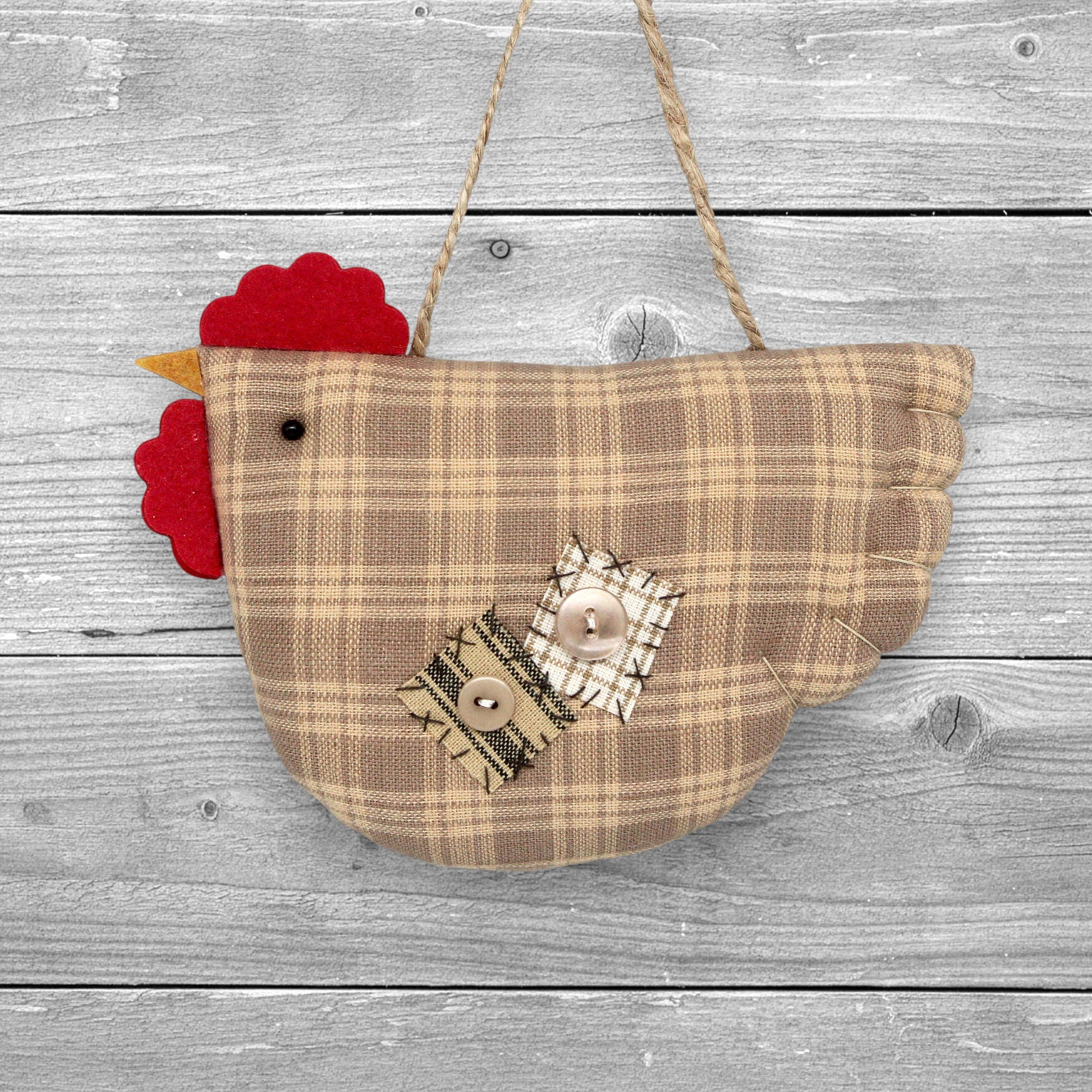 Fabric chicken-shaped ornament with plaid pattern and red comb on a white background