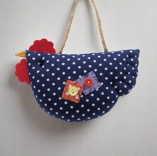 Decorative hanging chicken with blue polka dot body and colorful accents on a white background