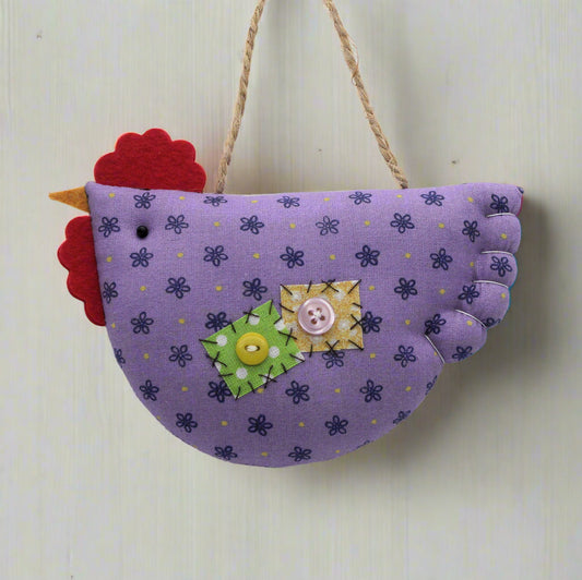 Purple fabric chicken decoration with colorful accents on a white background