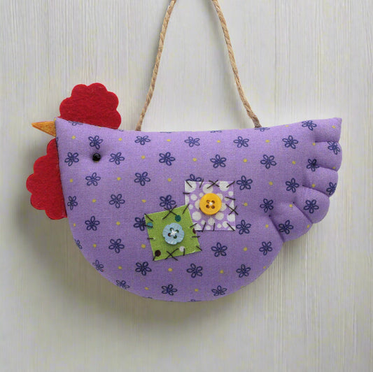 Purple fabric chicken decoration with colorful details on a white background