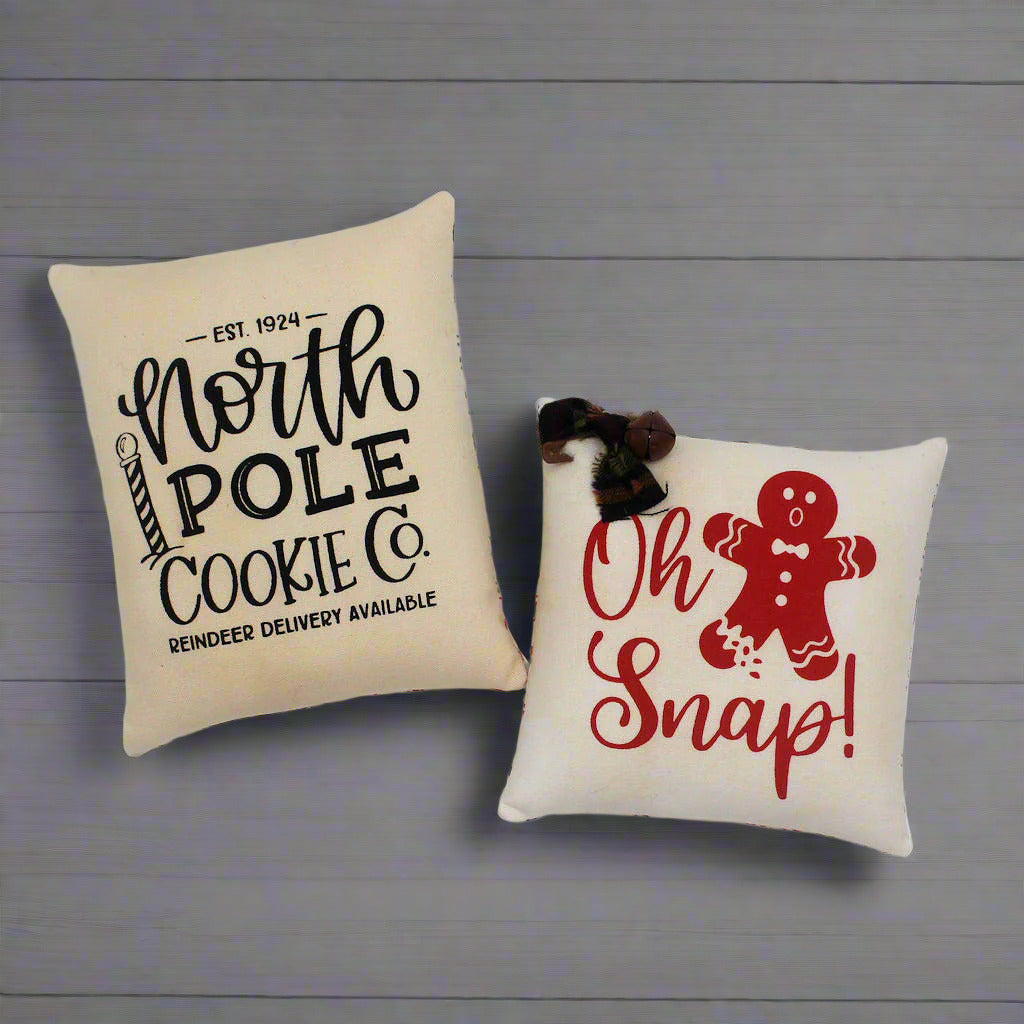 Set of two screen printed mini pillow bowl fillers with cookie and gingerbread designs