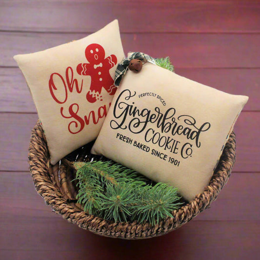 Set of two screen printed mini pillow bowl fillers with cookie and gingerbread designs