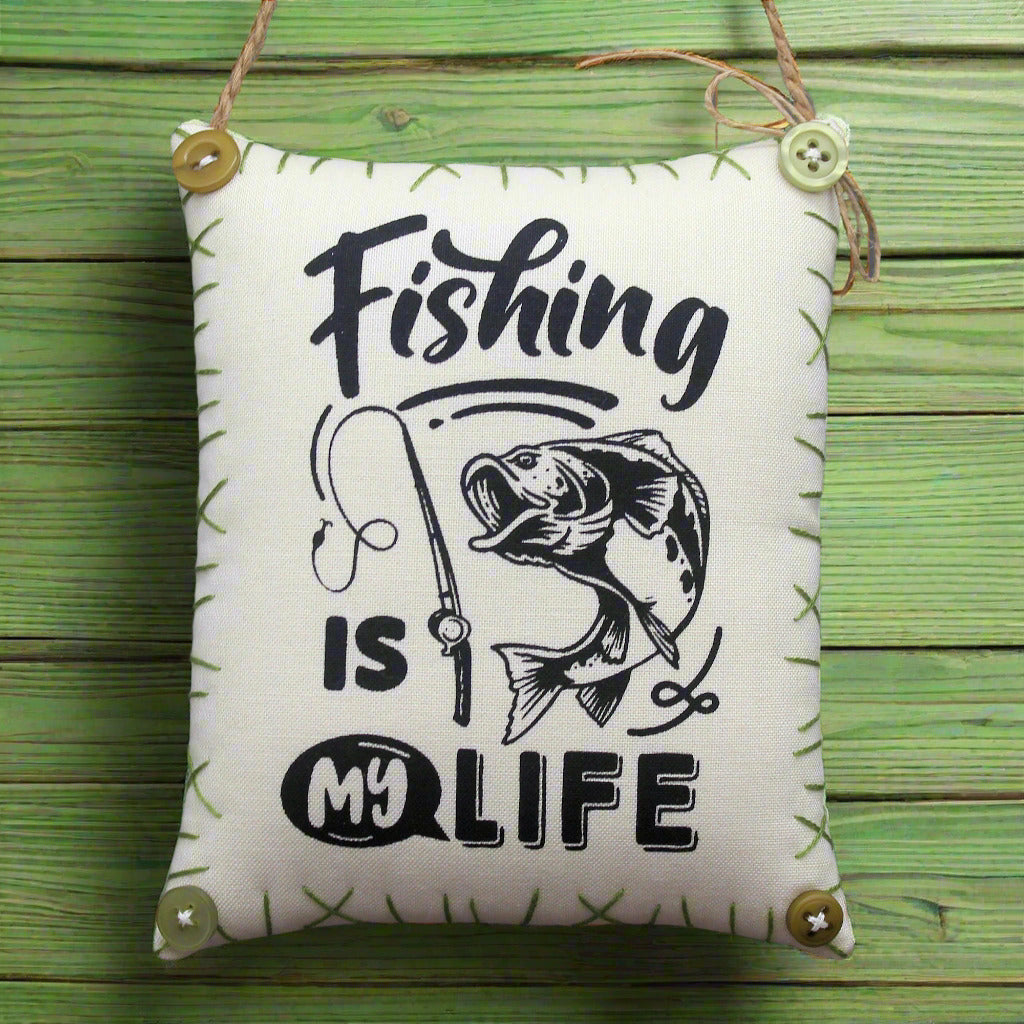 Small fabric sign with 'Fishing is my life' text and fish illustration