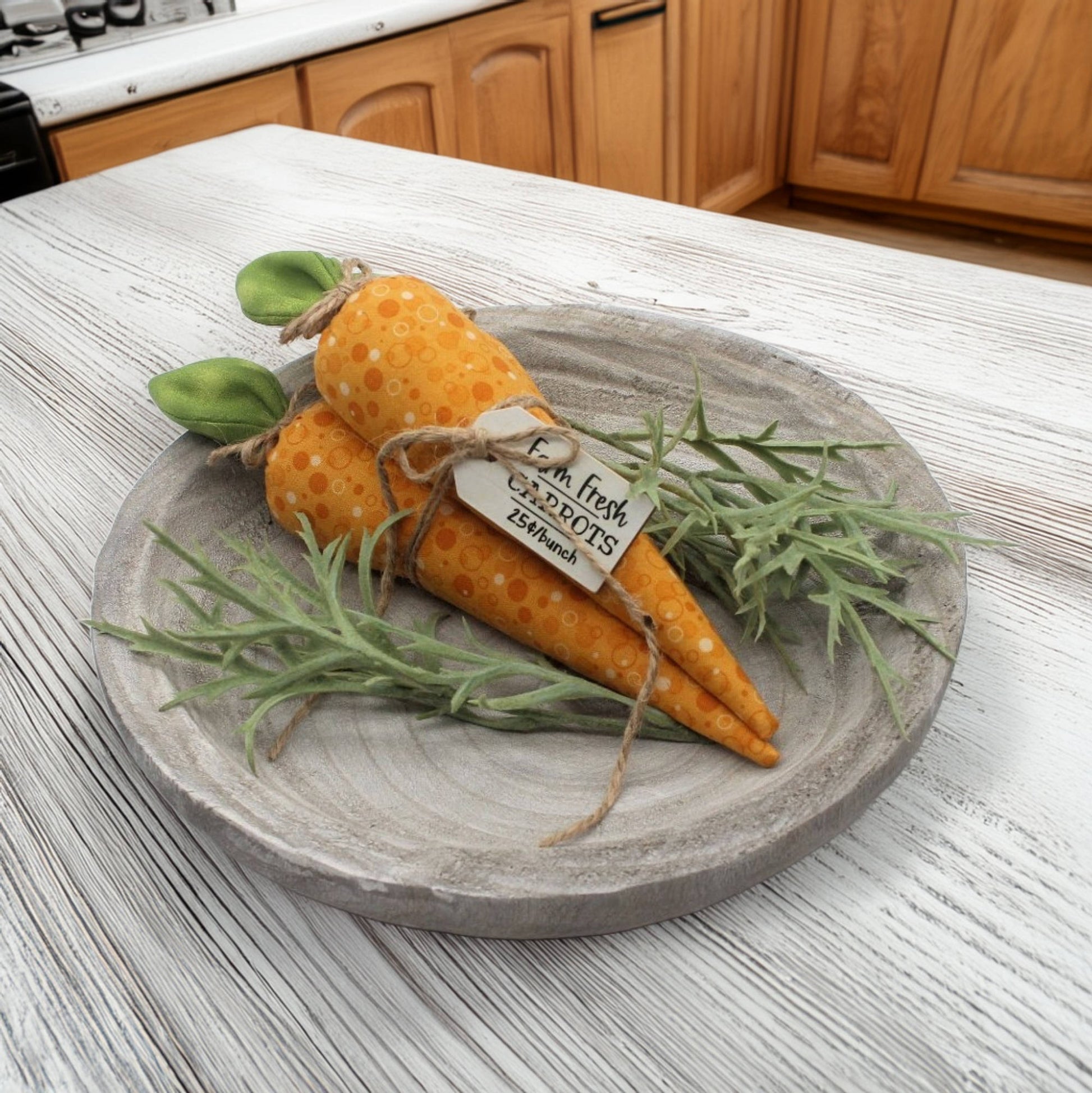Decorative carrots on a wooden plate with a kitchen background