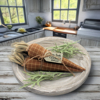 Decorative carrots on a wooden board with a kitchen background