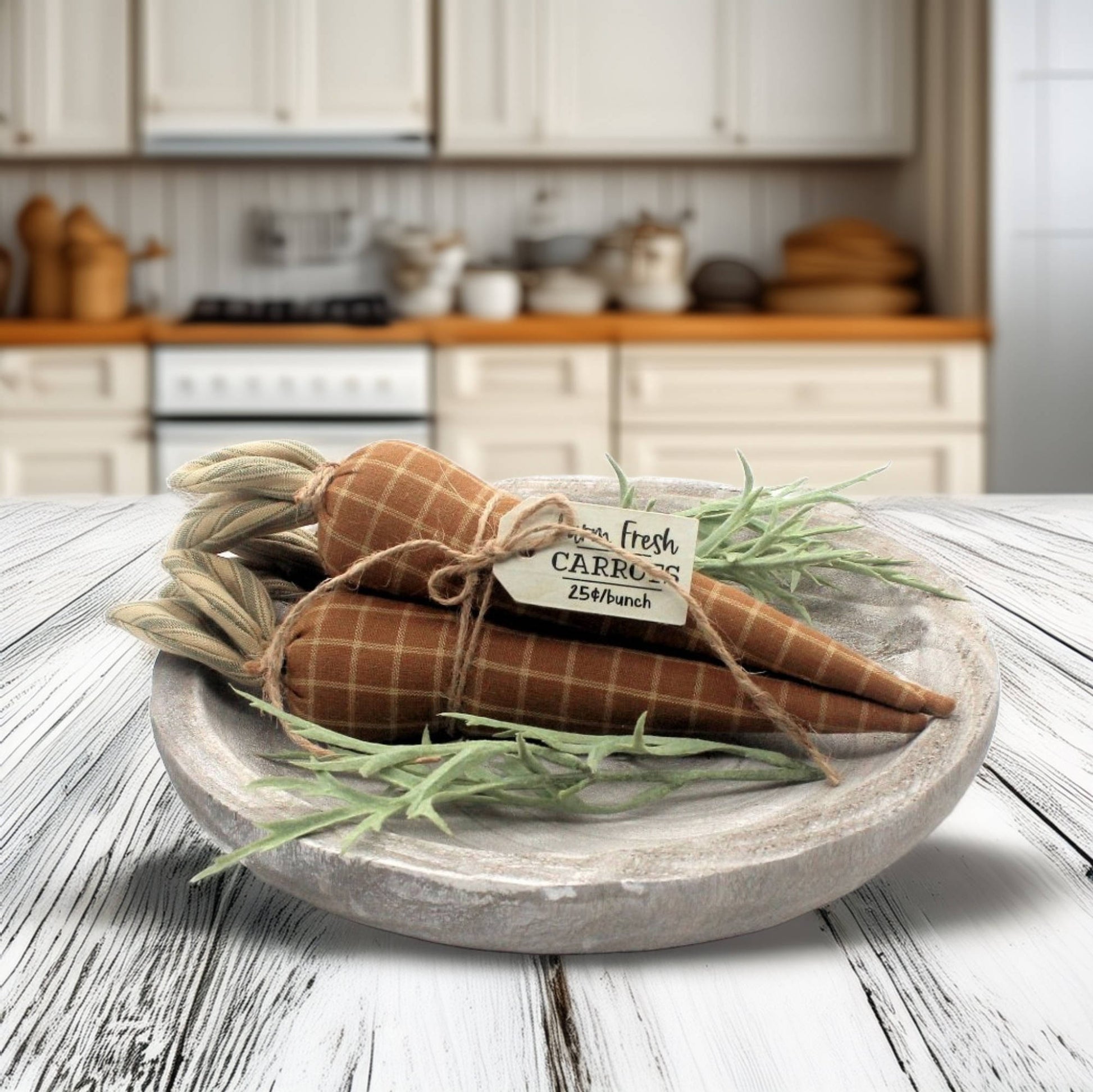 Decorative carrots in a wooden bowl with a kitchen in the background