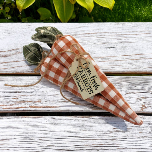 Decorative fabric carrot bundle with a checkered pattern on a wooden surface