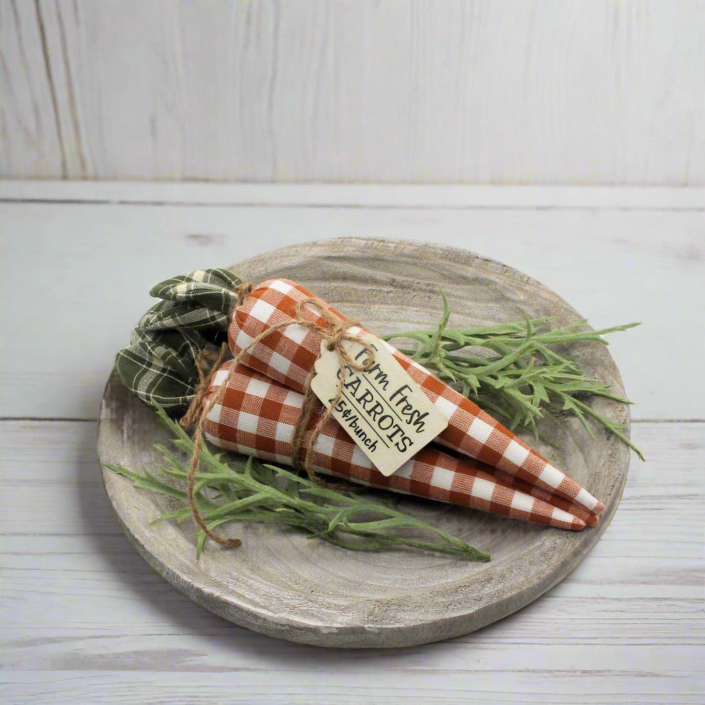 Decorative homespun fabric carrots shelf sitter on a wooden plate