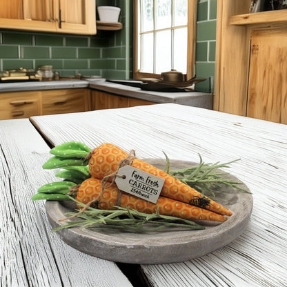 Decorative carrots on a wooden plate with a kitchen background