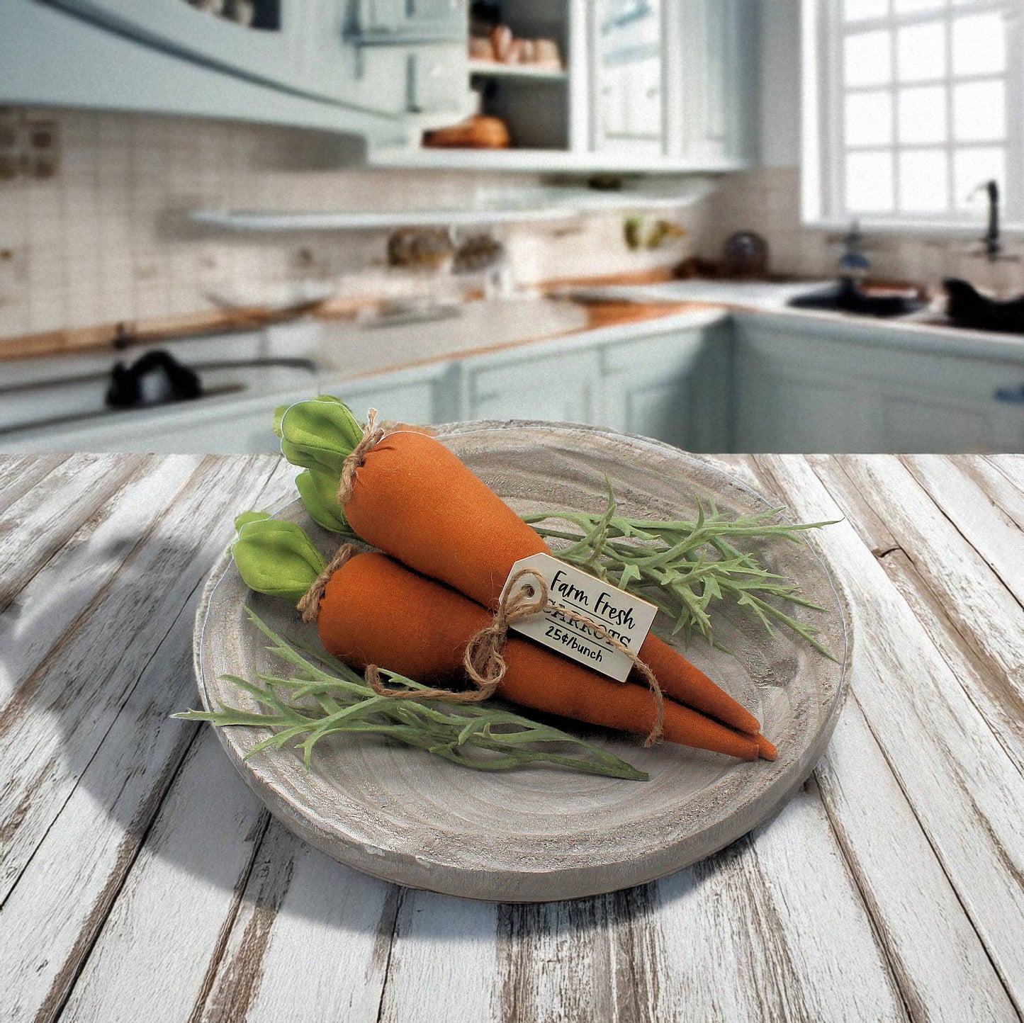 Decorative fabric carrots on a wooden plate with a kitchen in the background