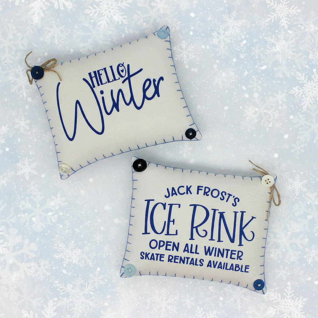 Two decorative signs with winter-themed text on a snowy background