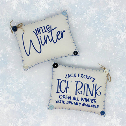 Two decorative signs with winter-themed text on a snowy background
