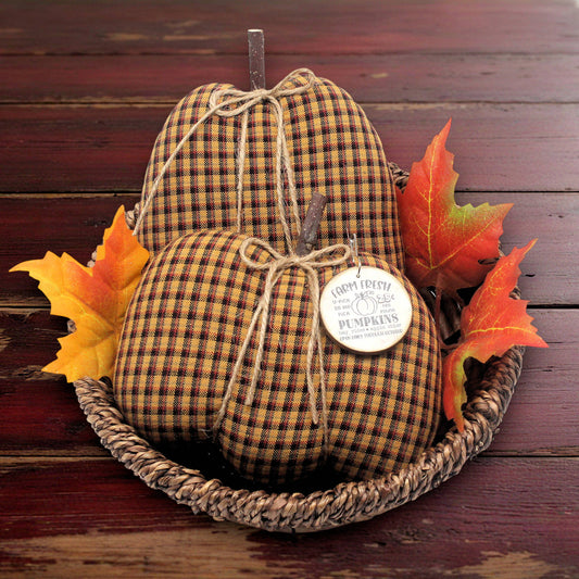 Set of two pumpkin bowl fillers for autumn sewn from a golden weave homespun fabric with jute twine ribs and a wooden tag.
