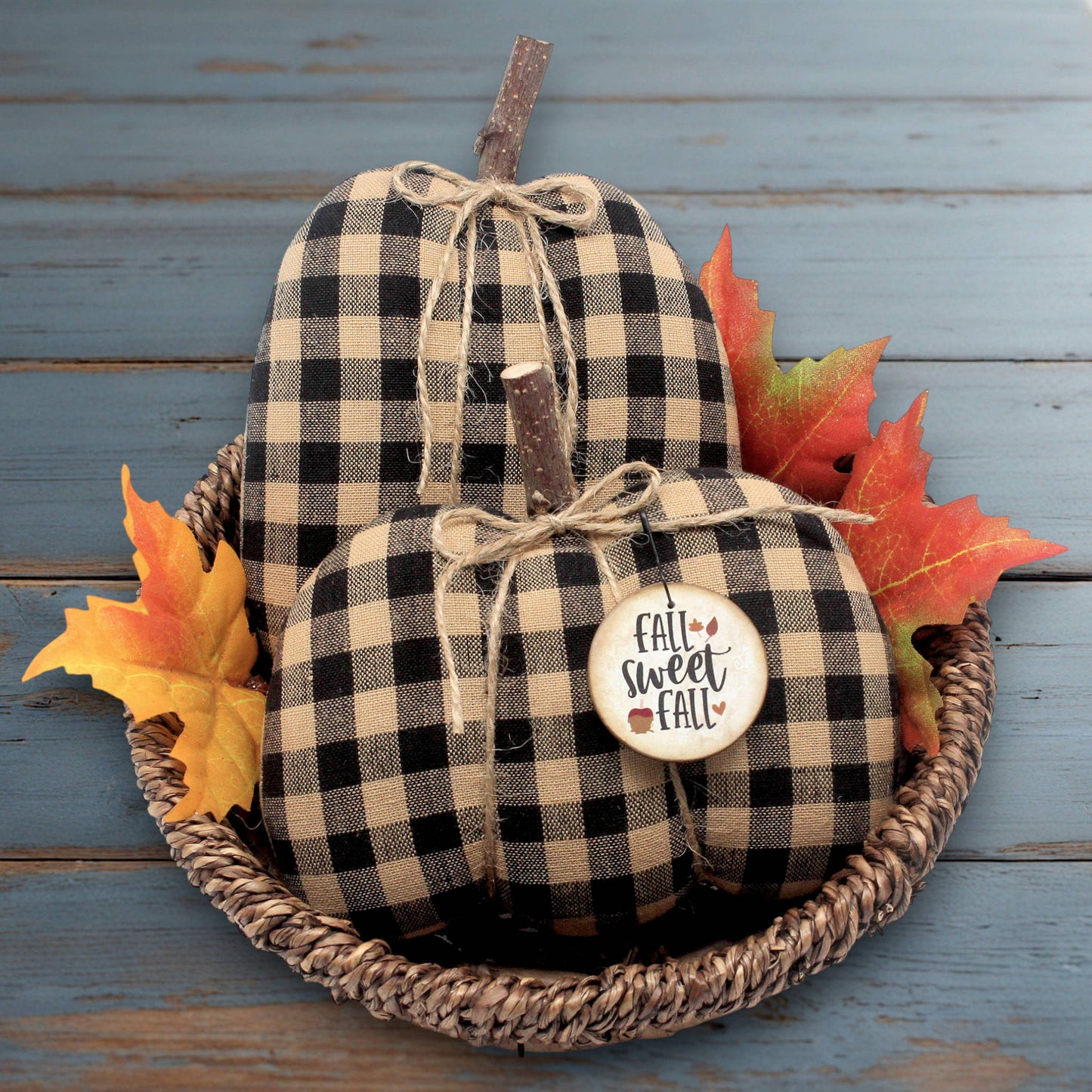Set of two country primitive pumpkin bowl fillers for autumn sewn from black and tan checked homespun fabric.  The pumpkins have stick stems and a wooden tag.