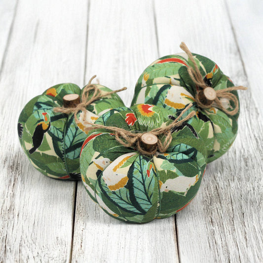Decorative pumpkins with animal patterns on a wooden surface