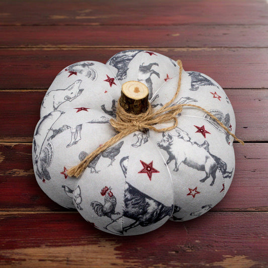 Decorative pumpkin with animal print and twine on a wooden surface