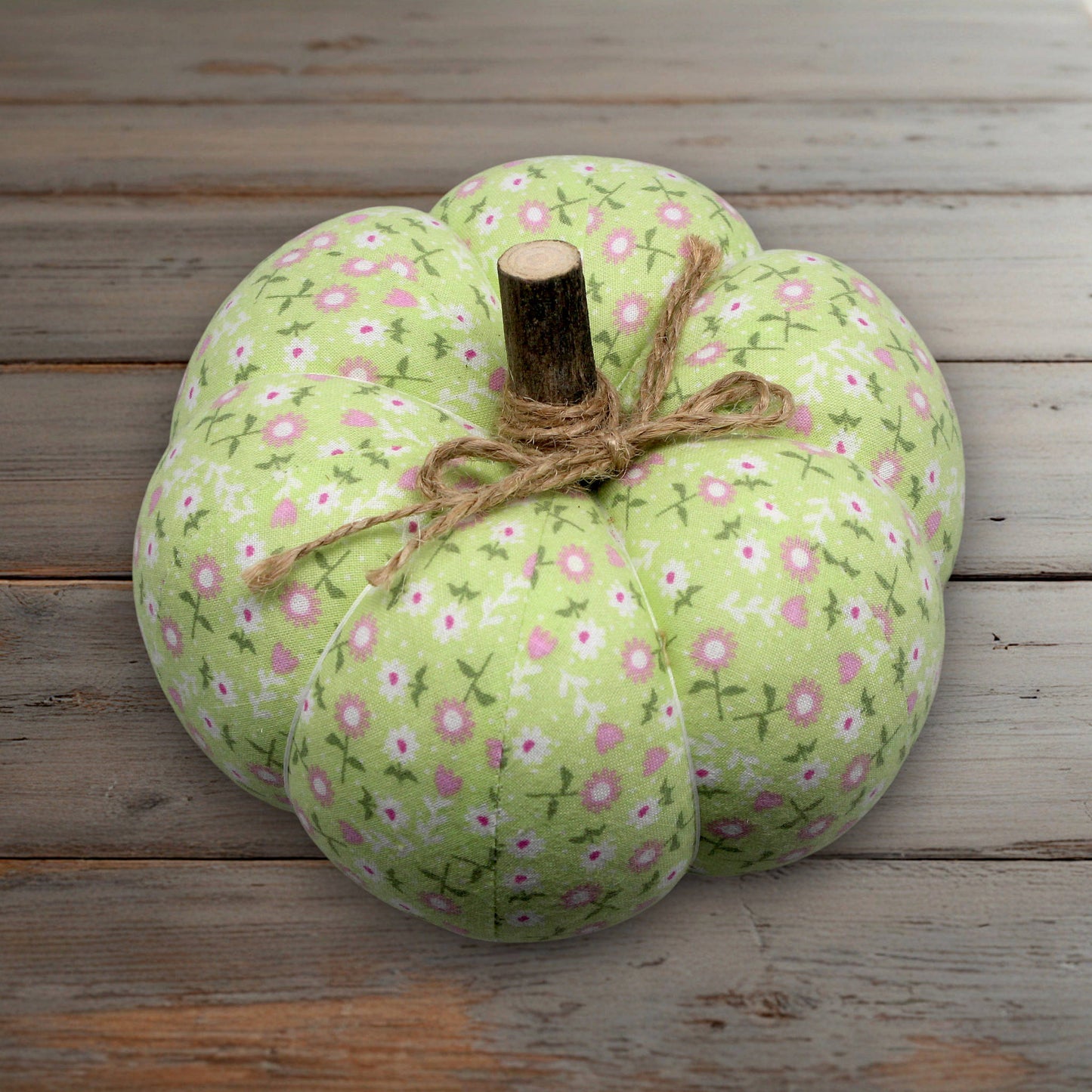 Decorative fabric pumpkin in a light green pastel floral design