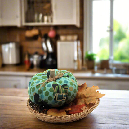 Decorative pumpkin with polka dot pattern in a woven basket