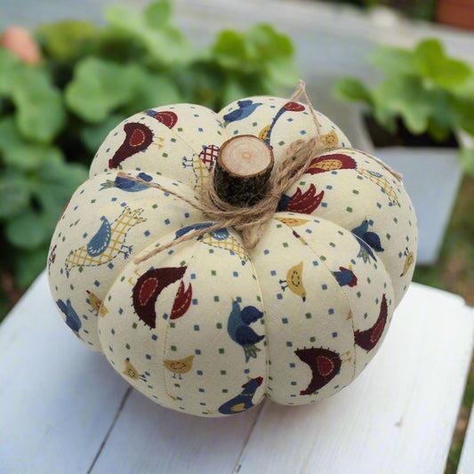 Decorative fabric pumpkin with a folk art bird design