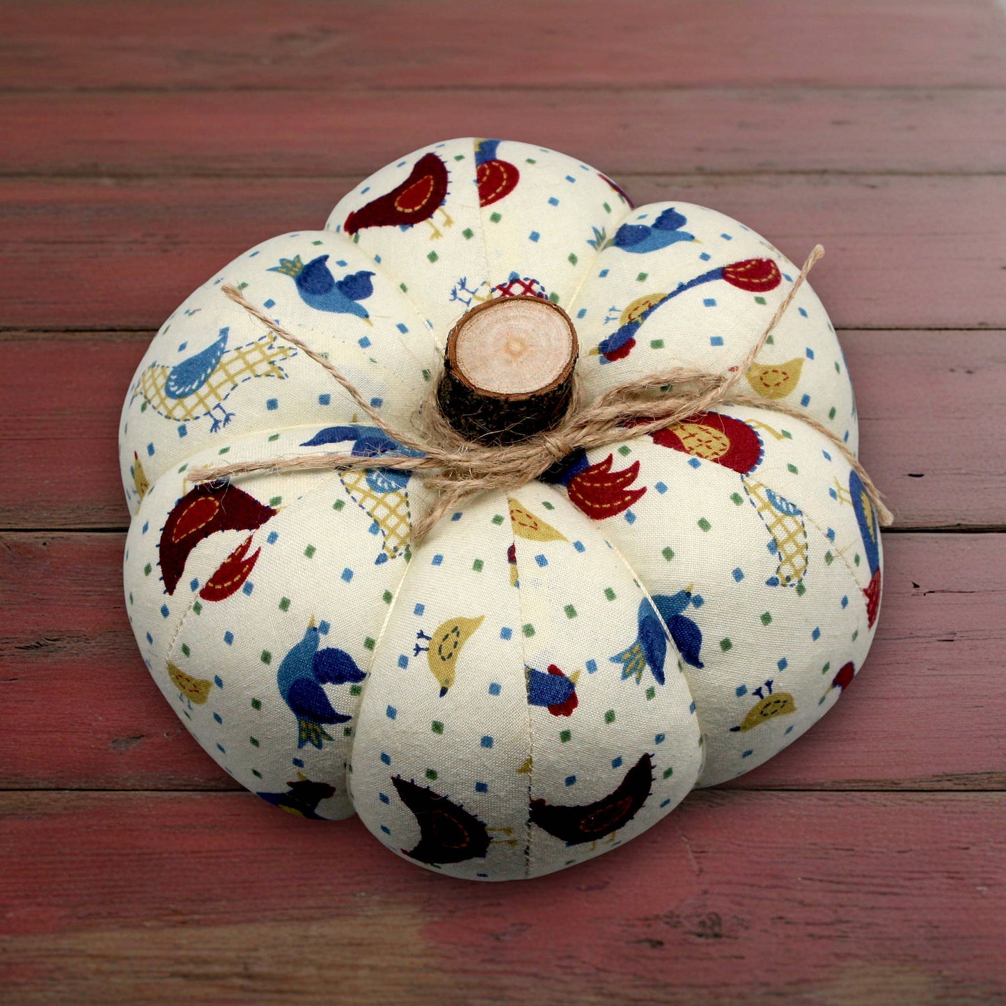 Decorative fabric pumpkin with a folk art bird design