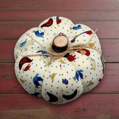 Decorative fabric pumpkin with a folk art bird design
