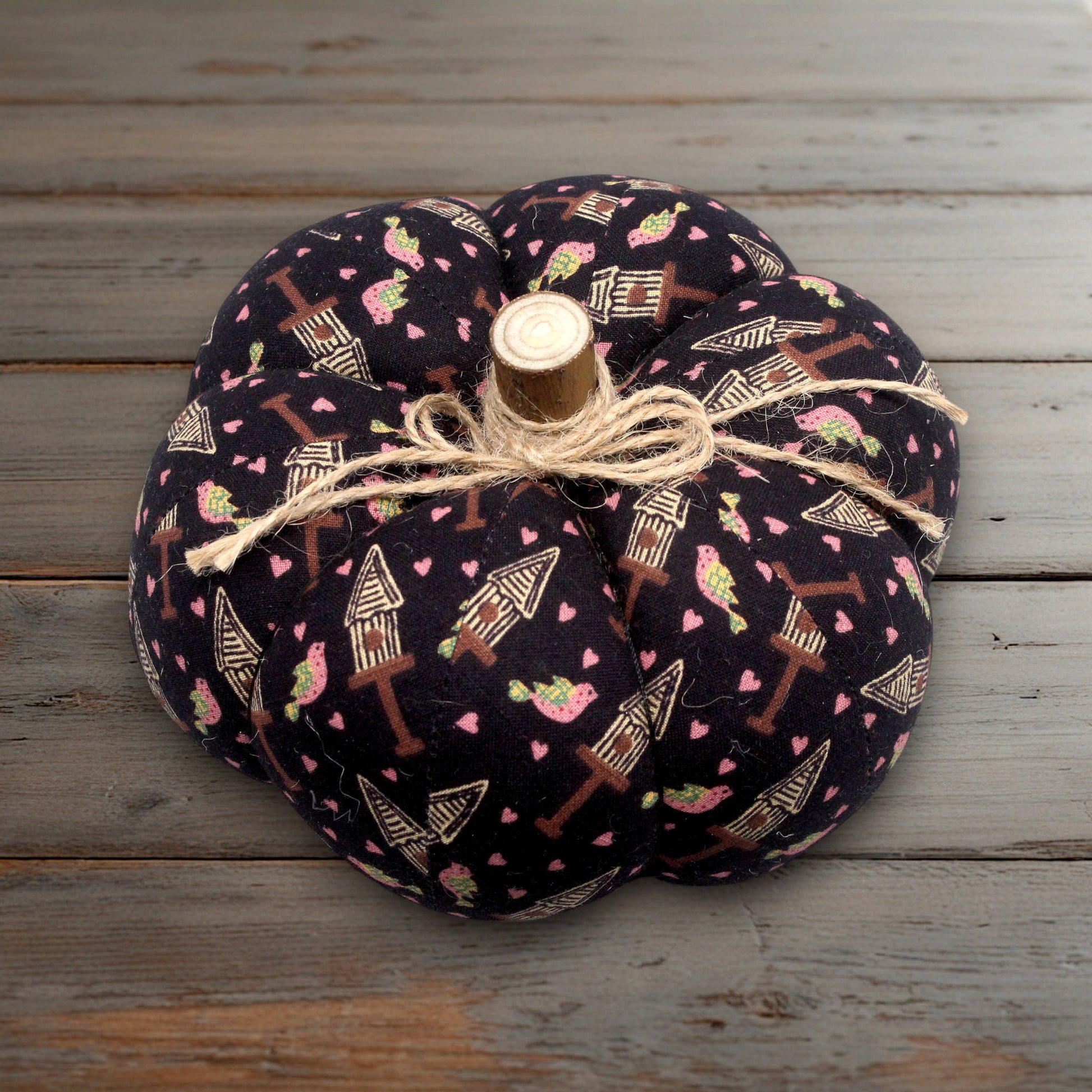 Decorative pumpkin with fabric pattern on a wooden surface