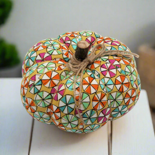 Decorative fabric pumpkin with a colorful candy wheel design
