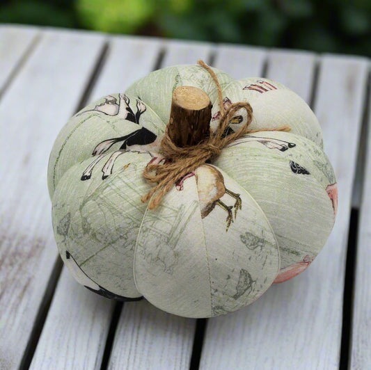Decorative pumpkins with farmhouse design design on a wooden surface