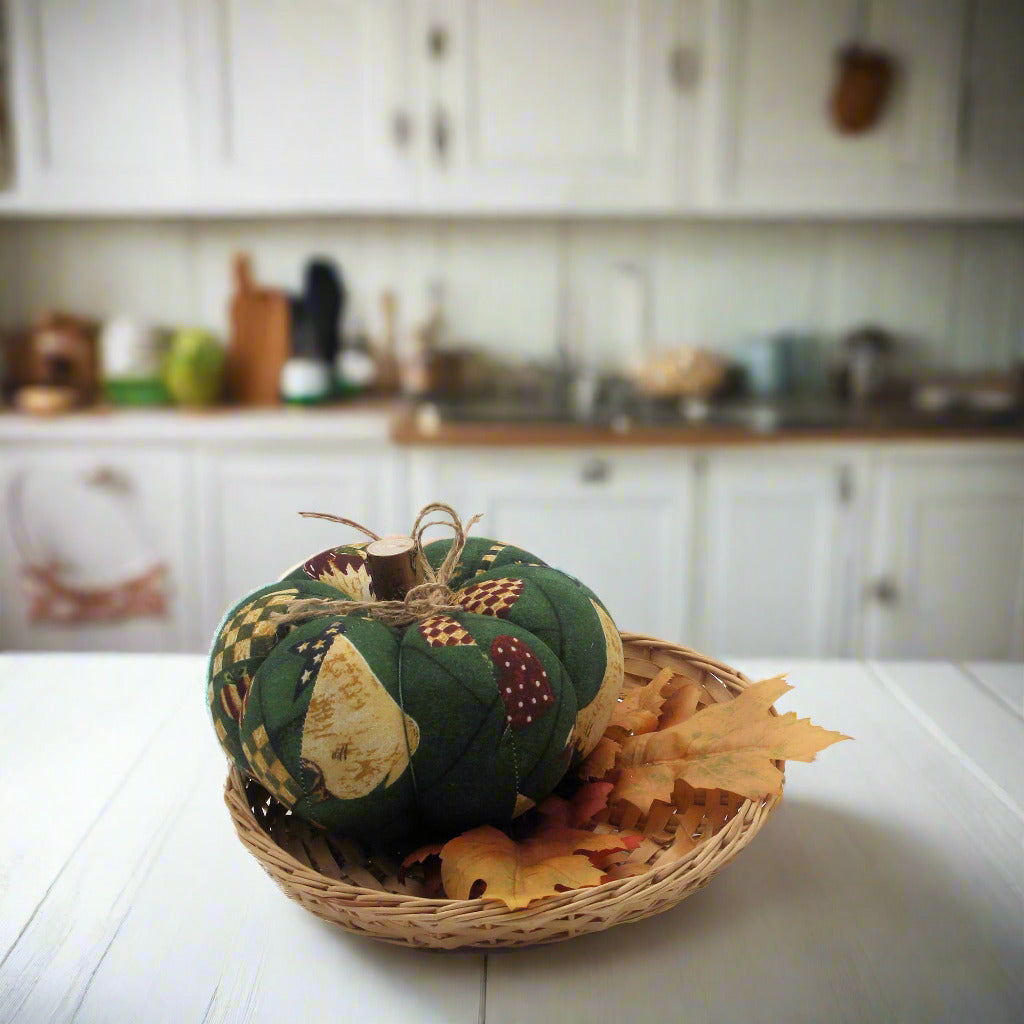 Decorative pumpkin in a woven basket on a kitchen counter