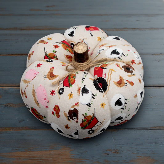 Decorative pumpkin with a farm animal print on a wooden surface