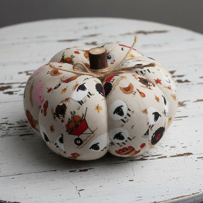 Decorative pumpkin with autumn-themed pattern on a rustic wooden surface
