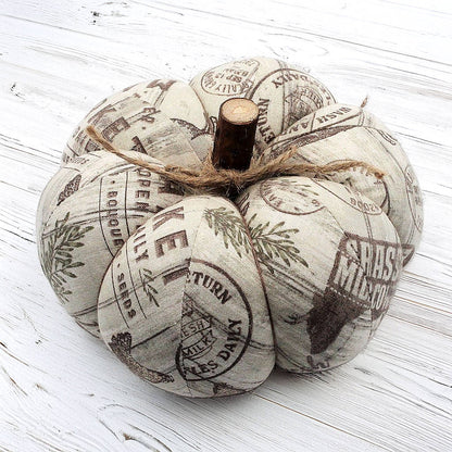 Decorative pumpkin with farm market print on a white wooden surface