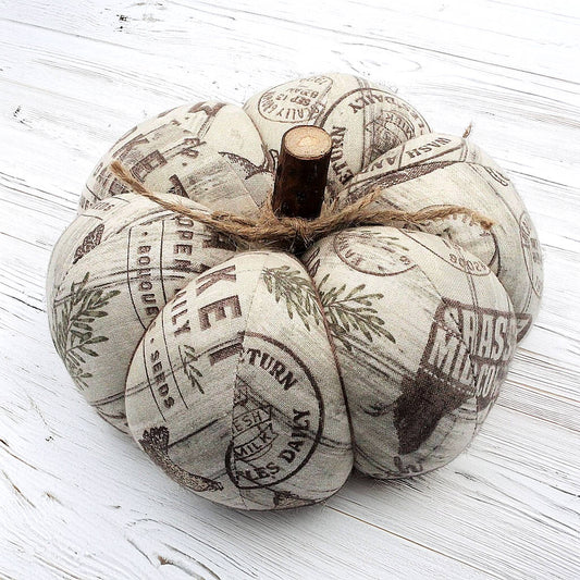 Decorative pumpkin with farm market print on a white wooden surface