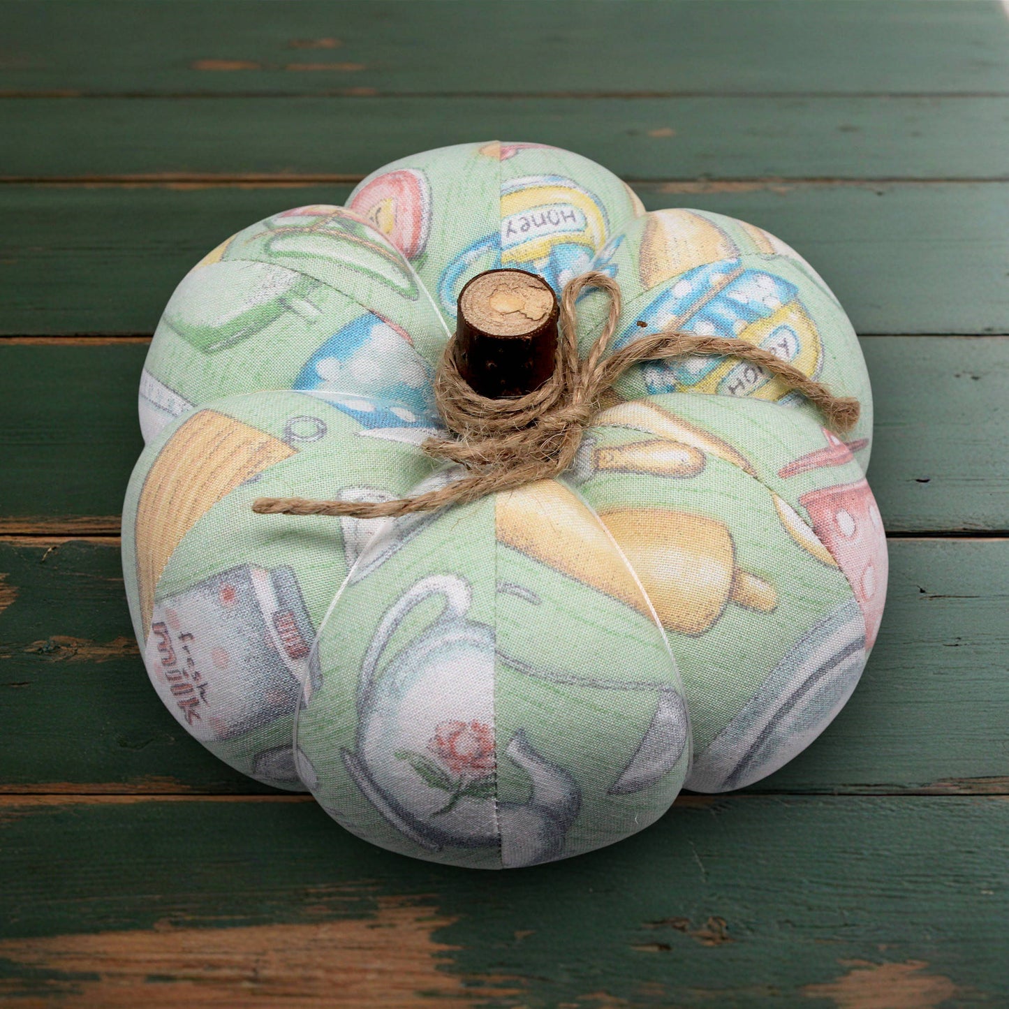 Decorative fabric pumpkin with a rustic appearance on a white wooden surface