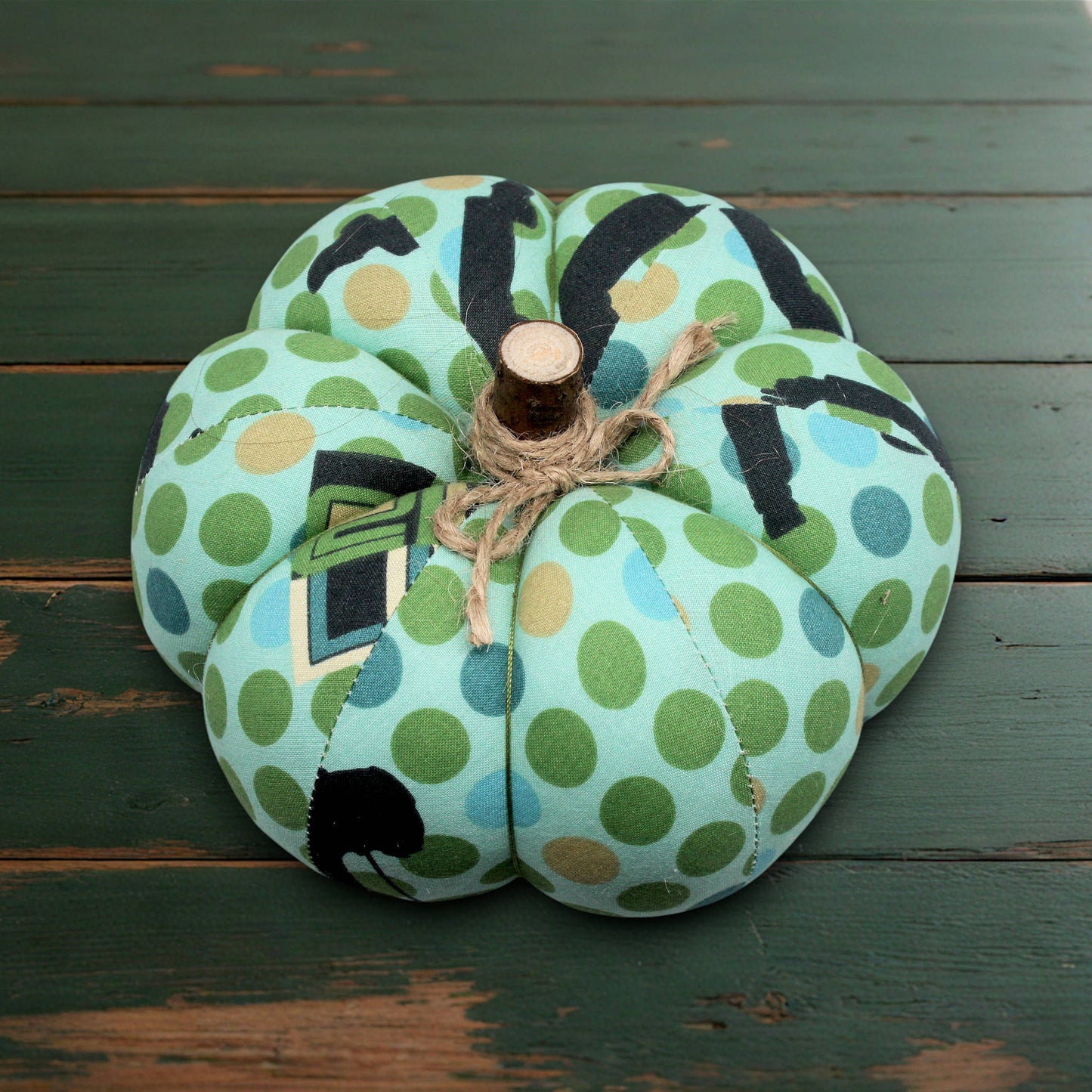 Decorative fabric pumpkin with a green polka dot design