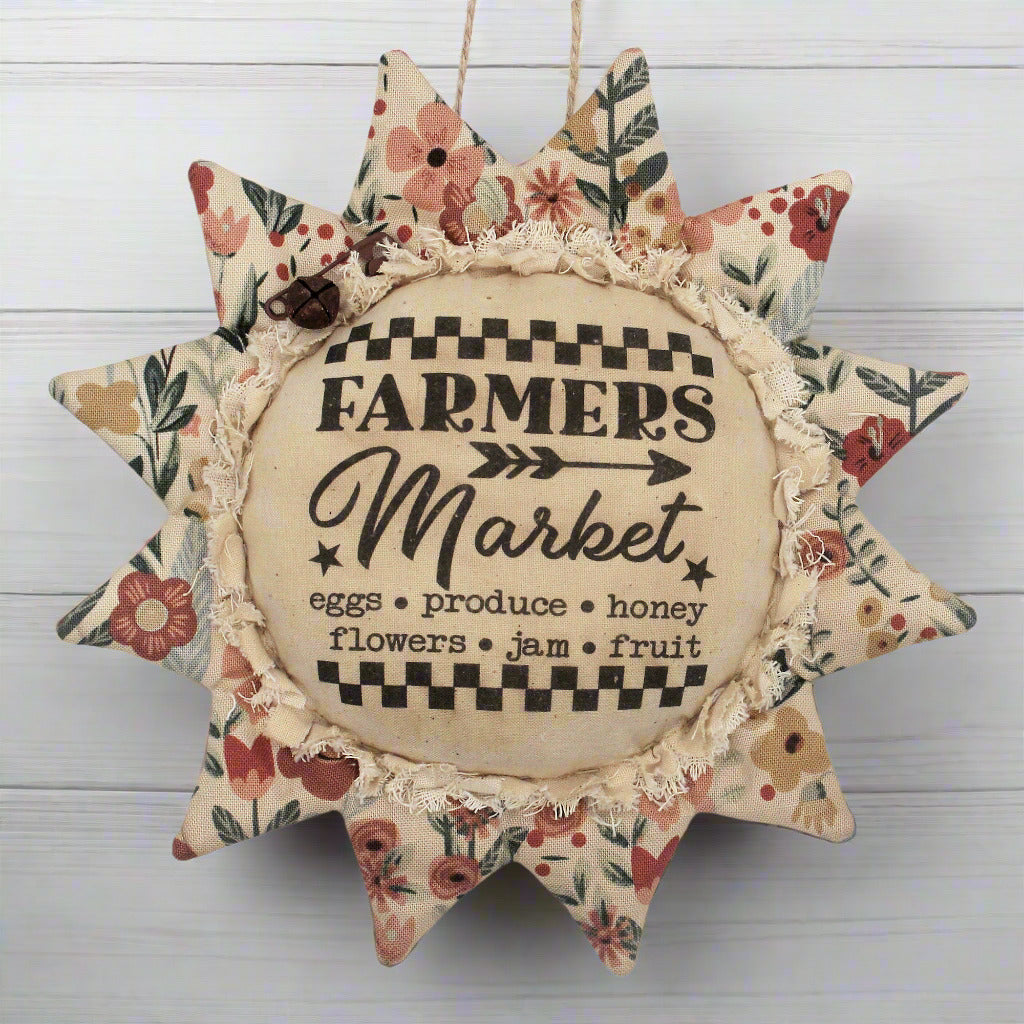 Primitive fabric sunflower ornament featuring an advertisement for a farmers market
