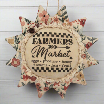 Primitive fabric sunflower ornament featuring an advertisement for a farmers market