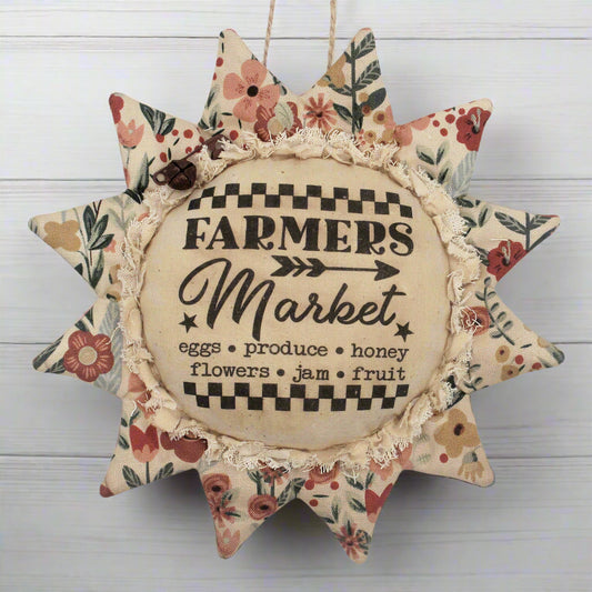 Primitive fabric sunflower ornament featuring an advertisement for a farmers market